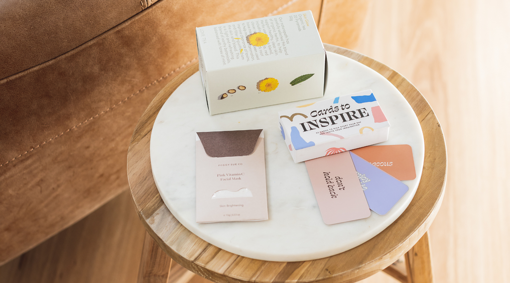 Products included in gift boxes for Sunshine Coast gift delivery service, including: organic tea, clay face mask and affirmation cards to inspire.