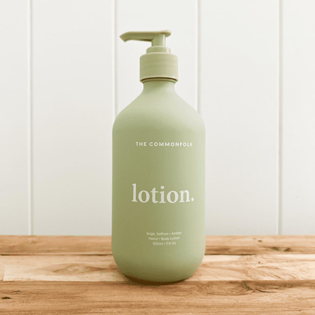 A bottle of The Commonfolk Collective hand and body lotion in a sage recycled bottle.