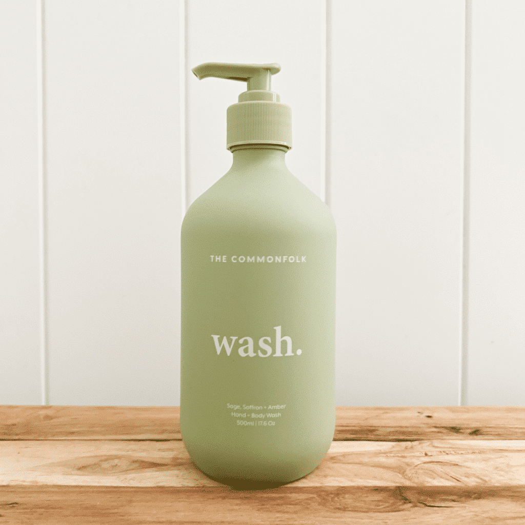 Pump bottle of The Commonfolk Collective natural hand and body wash in a recycled sage bottle.