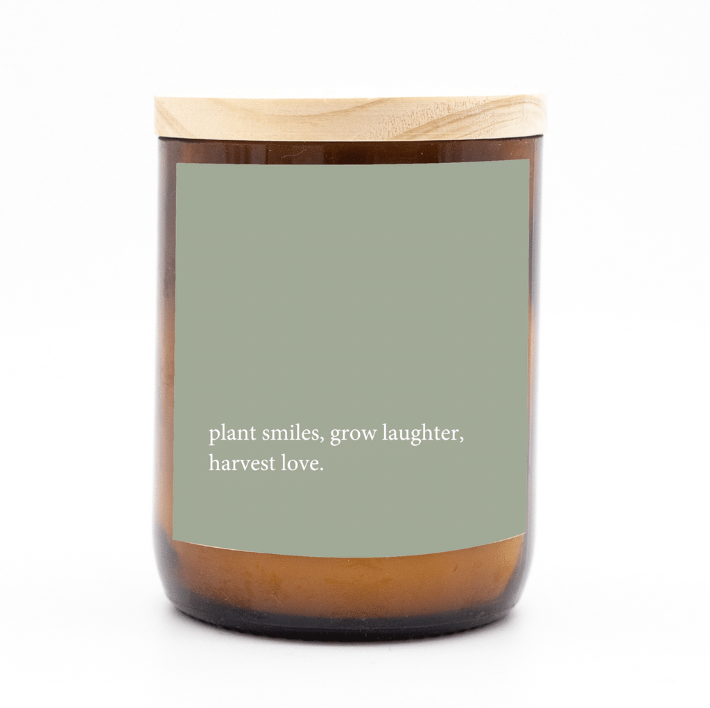 Single natural candle in an amber jar with wooden lid and a heartfelt quote.